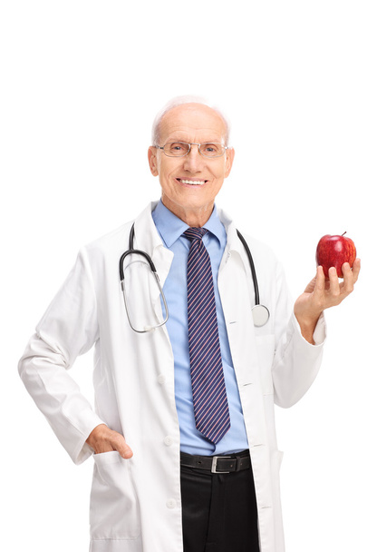 Mature doctor holding a red apple - Foto, Bild