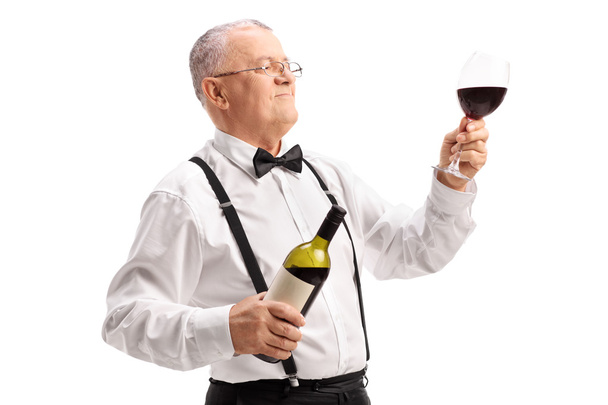 mature man holding a glass of wine - Photo, Image