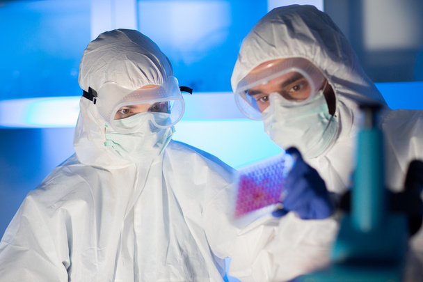 close up of scientists making test in chemical lab - Fotó, kép