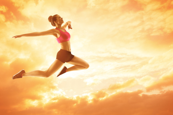 Sport Woman Running, Athlete Girl in Jump, Jumping and Flying Sunny Sky - Fotografie, Obrázek