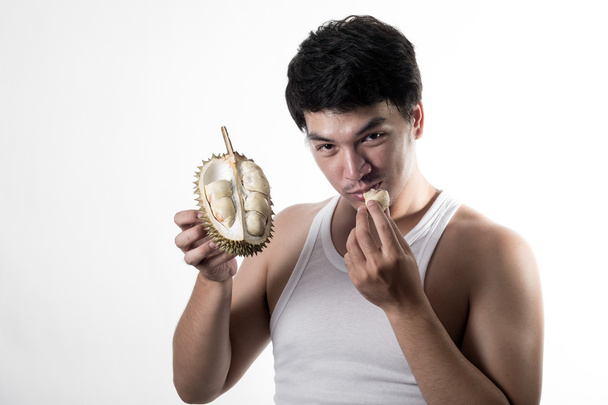 Азиатский мужчина ест дуриан
 - Фото, изображение