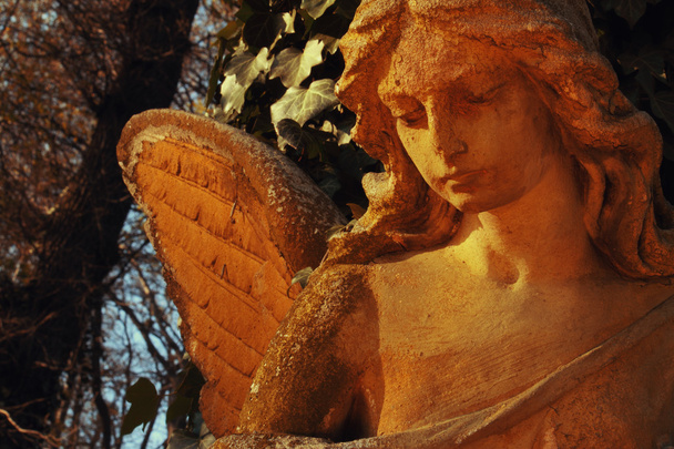 golden angel in the sunlight (antique statue) - Photo, Image