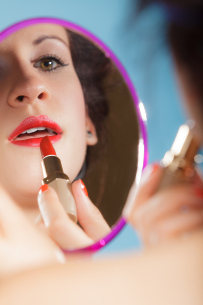  Woman applying red lipstick - Photo, image