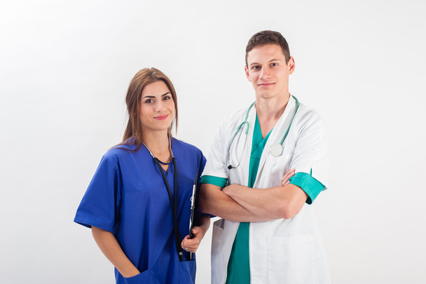 Medical professionals standing isolated. Young caucasian man and young woman nurse in medical scrubs. - Fotografie, Obrázek