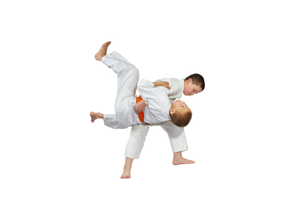 Boys are training judo throw on a white background - Photo, Image