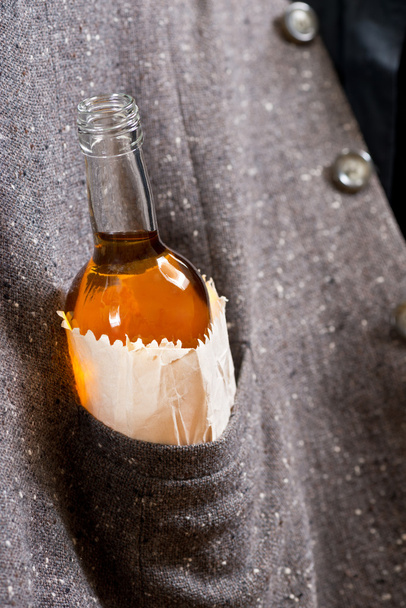 hard drinker hides a bottle - Foto, imagen