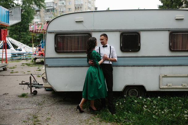 man and woman is hidden from view behind a trailer - Photo, Image