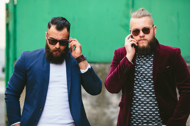 Two bearded businessman looking at phone - Photo, Image