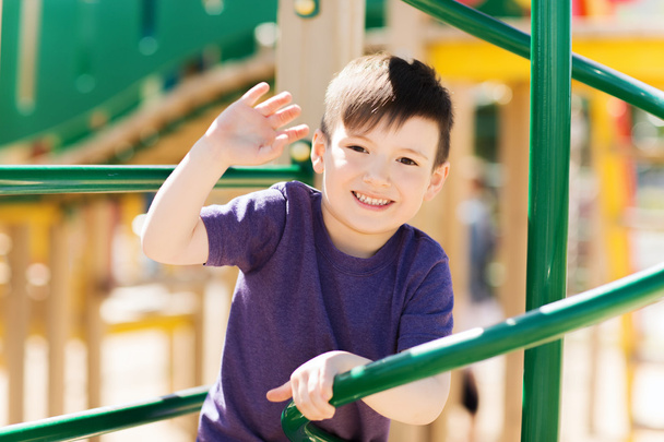 happy little boy climbing on children playground - Фото, изображение