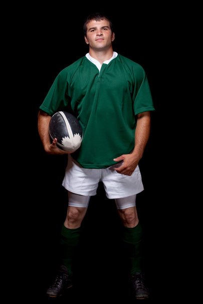 Male rugby player. Studio shot over black. - Photo, image