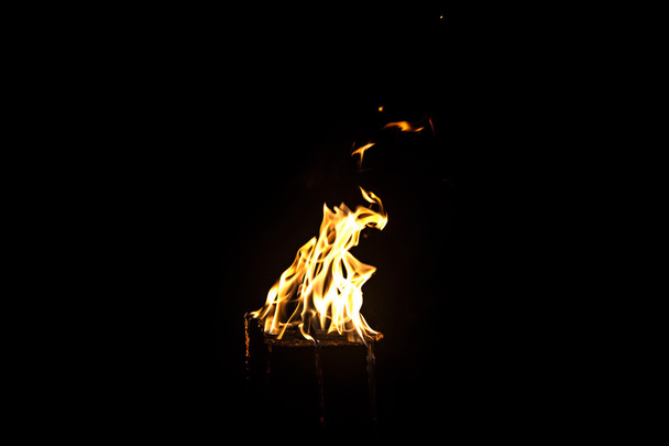 Image of light yellow flame by night - Фото, зображення
