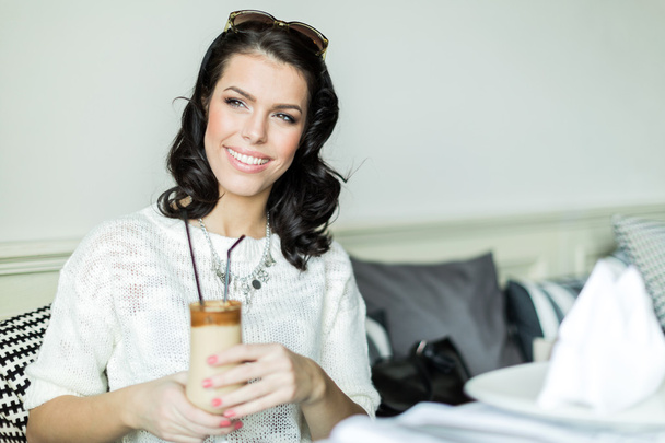 Gorgeous lady holding her coffee - Photo, image