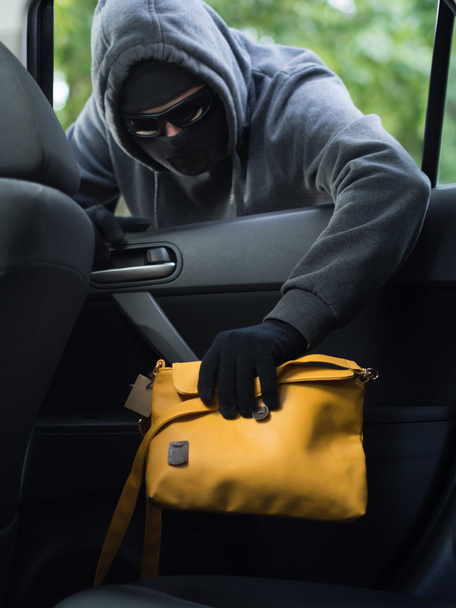 Transportation crime concept .Thief stealing bag from the car - Fotoğraf, Görsel