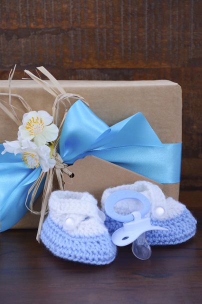 Baby Shower Gift with Booties on Dark Wood - Photo, Image
