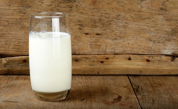 Glass with milk on the wooden background - Photo, image