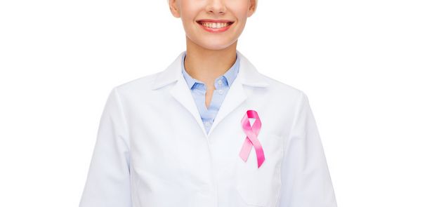 female doctor with breast cancer awareness ribbon - Foto, Imagen