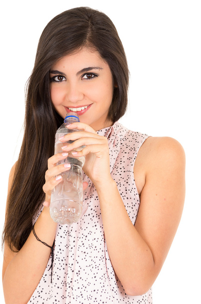Beautiful young girl drinking water from a plastic bottle - Photo, image