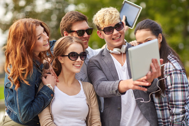 students or teenagers with tablet pc taking selfie - Zdjęcie, obraz