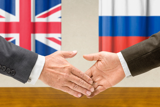 Representatives of the UK and Russia shake hands - Photo, Image