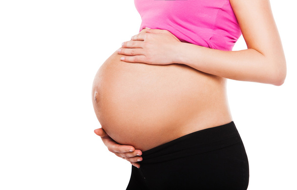 Крупный план милого беременного живота, изолированного на белом
 - Фото, изображение
