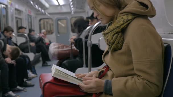 Woman Reading a Book in Tube Train - Πλάνα, βίντεο