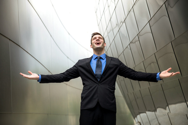 Conceptual freedom wealth success power happiness in a suit tie with urban architecture background - Foto, Bild