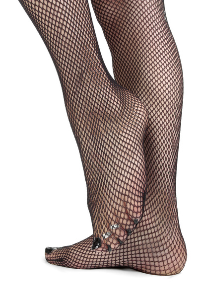 Womanfeet wearing fishnet tights over white background - Foto, Imagem