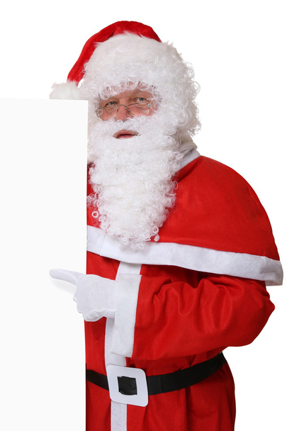 Santa Claus pointing on Christmas at empty banner with copyspace - Photo, Image