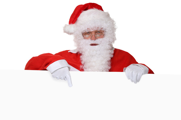 Santa Claus con barba apuntando a la Navidad con la bandera vacía ingenio
 - Foto, imagen