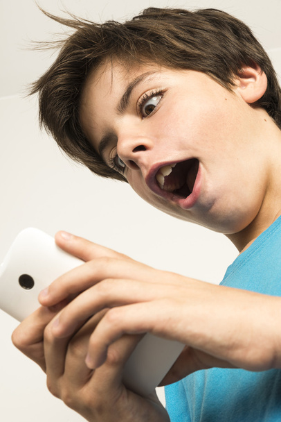 Boy touching a smartphone - Foto, afbeelding