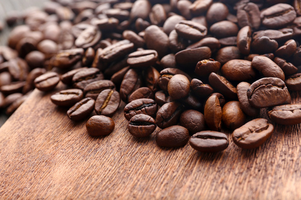 Coffee beans on wooden background - Valokuva, kuva