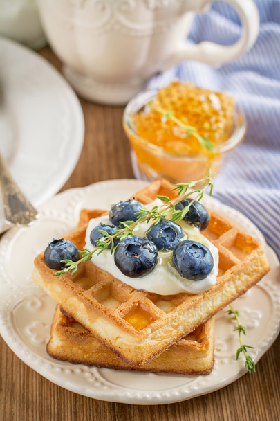 Homemade fresh crispy waffles for breakfast with blueberries and honey - Photo, image