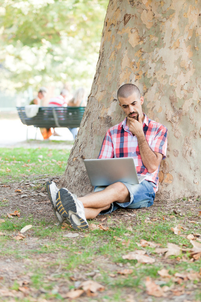 Young Man With Computer at Park - Фото, изображение
