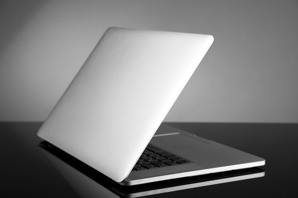 Laptop on gray background - Фото, изображение