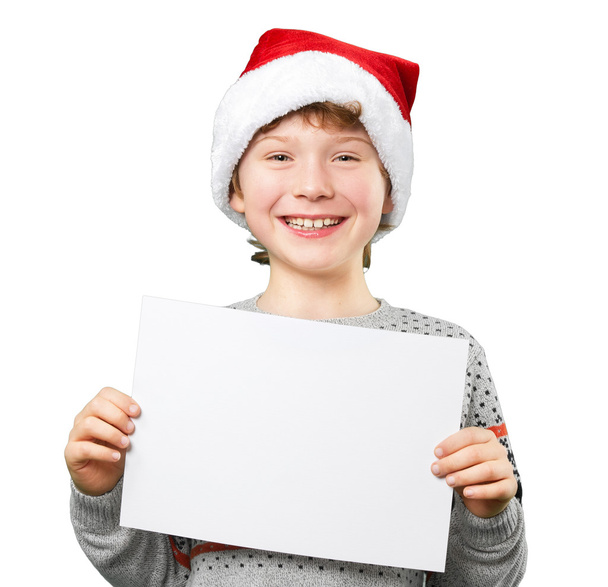Portrait of a boy in christmas hat holding white blank. Isolated - Foto, Bild