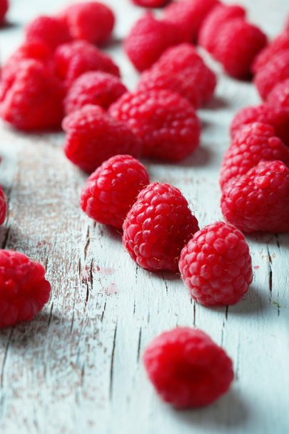 Fresh raspberries on wooden background - Fotó, kép