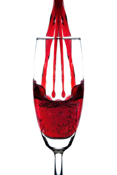 Red wine double pouring into champagne glass - Photo, Image