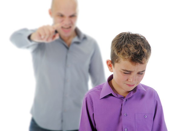Strict father punishes his son - 写真・画像