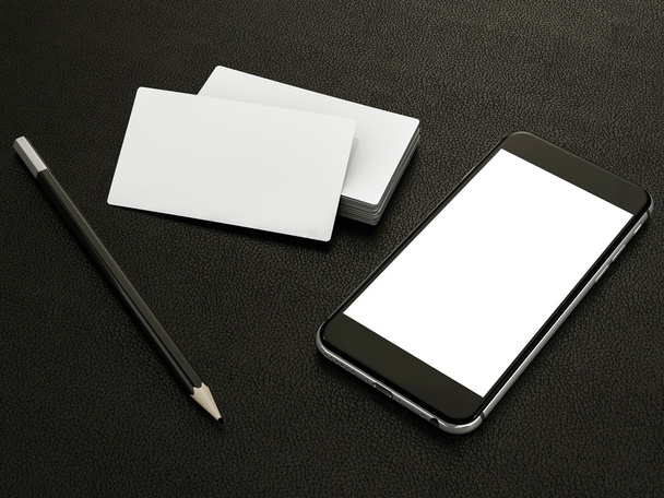 White business cards blank and smartfon mockup on leather background - Foto, imagen
