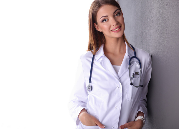 Doctor woman with stethoscope isolated on grey background - Foto, immagini