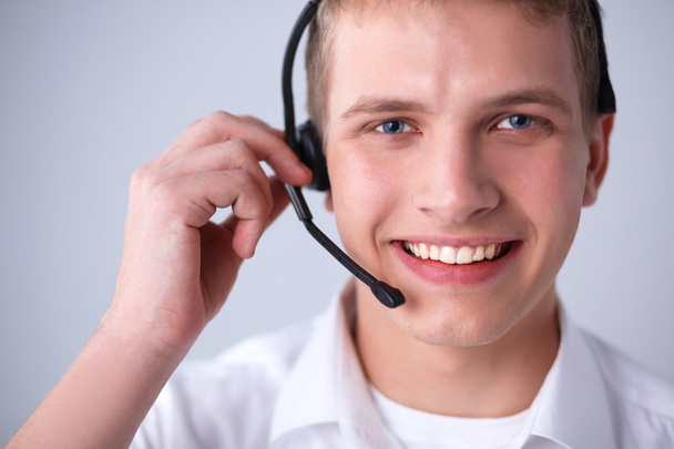 Customer support operator with a headset on white background - Foto, Bild