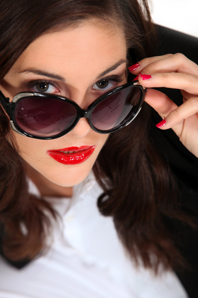 Brunette with captivating gaze and red lipstick - Photo, Image