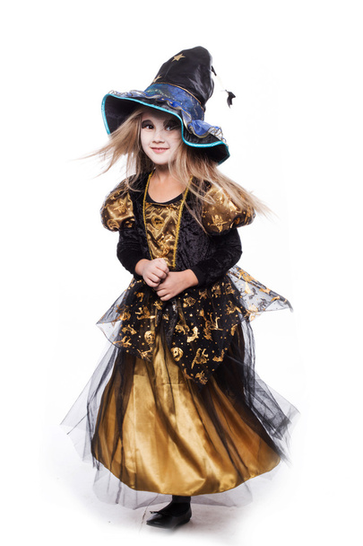 Adorable little blond girl wearing a witch costume smiling at the camera. Halloween. Fairy. Tale. Studio portrait isolated over white background - Foto, immagini