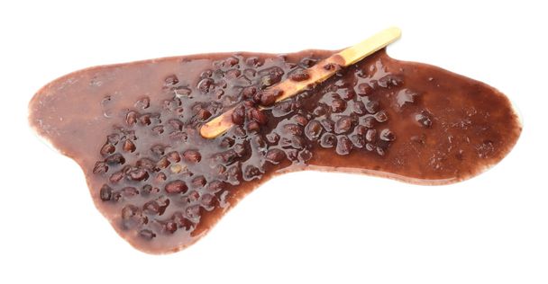 Red bean popsicle melting completely on a white background - Photo, Image