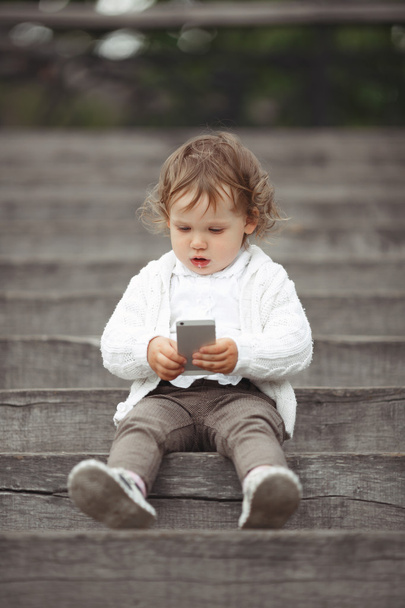 Little girl playing with mobile phone - Photo, Image