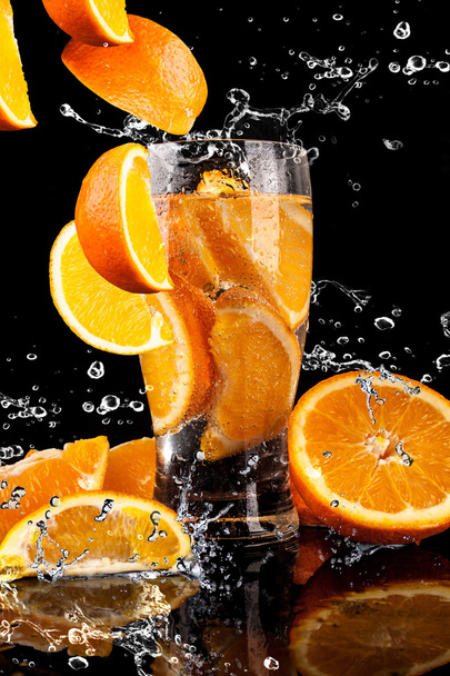 Orange fruits and Splashing water, drink - Fotó, kép