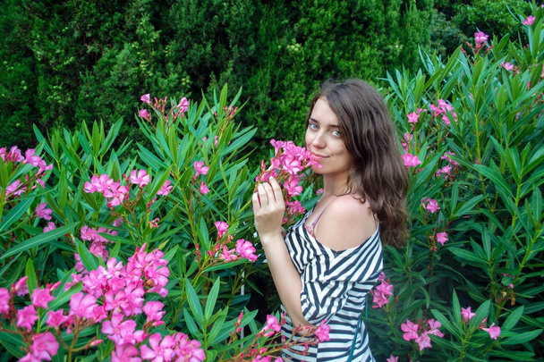 Portrait of a girl in the garden with flowers - Photo, Image