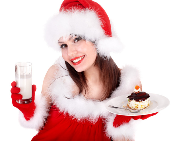 Chica en rojo santa hat comer pastel en el plato
. - Foto, Imagen