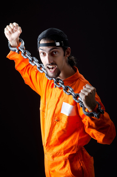 Inmate chained on black background - Photo, Image