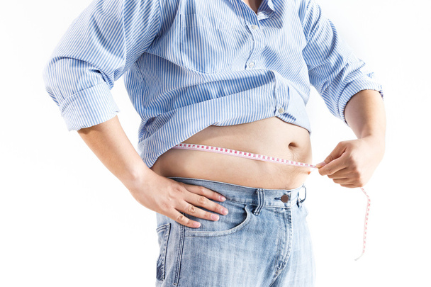 Fat man measuring his waist - Фото, изображение
